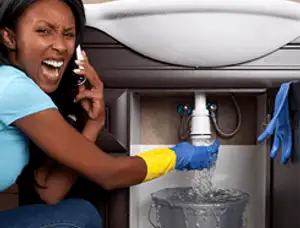 Emergency plumbing repair for a leaking sink drain under a bathroom vanity in Providence, RI